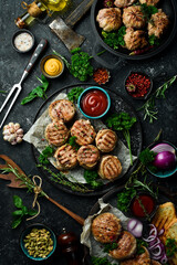 A set of fried meat, cutlets and shish kebab, handmade recipe. On a black stone background. Top...