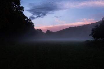 Naklejka na ściany i meble Amazing misty meadow in September sunset 