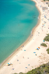 Aerial view on the beach Solanas with white sand, hills with green vegetation, sea with blue transparent water and village in the province Sinnai. Location Sardinia, Italy.
