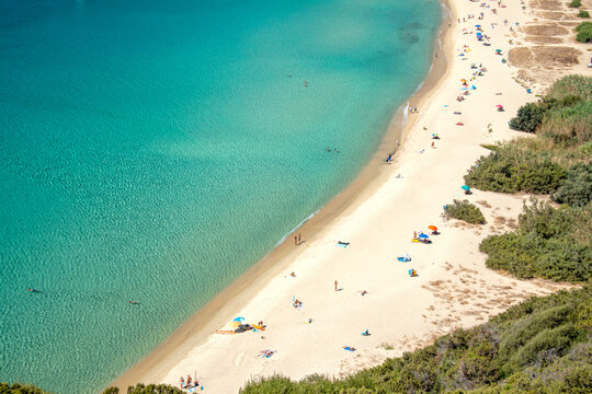 Aerial view on the beach Solanas with white sand, hills with green vegetation, sea with blue transparent water and village in the province Sinnai. Location Sardinia, Italy.
