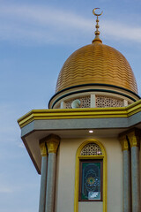 Golden color of mosque in Bandung Indonesia crescent moon on a copper-clad dome facing the blue sky