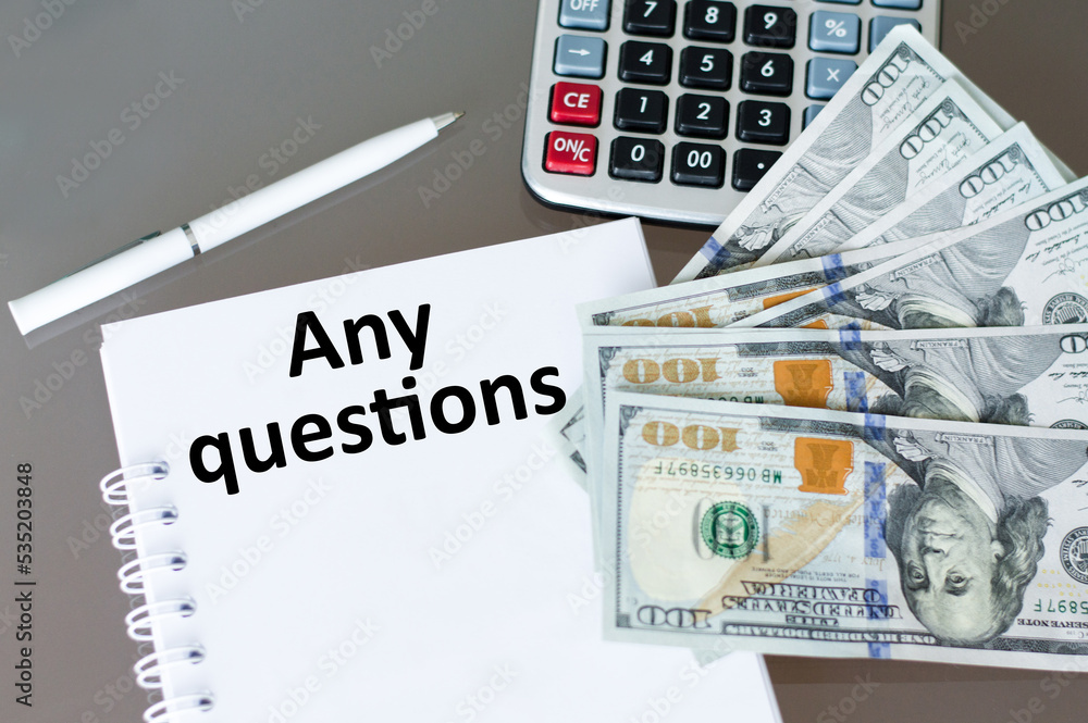 Poster any questions text on a business notebook the a table