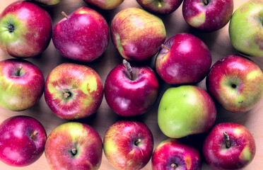 Concept for an simple autumn background. Close-up of fresh, organic apples on a wooden table. Flat lay, top view.