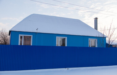 One-story house covered with snow.