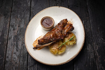 grilled meat with vegetables and spices on a black background
