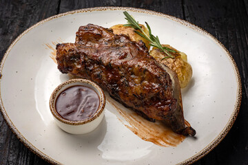 grilled meat with vegetables and spices on a black background
