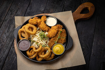 battered seafood in a pan on a black background
