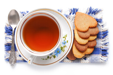 Cup of tea and homemade butter cookies in the shape of a heart