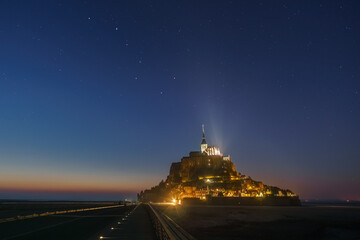 Night sky over le Mont Saint-Michel during twilight after sunset with stars and the constellation...