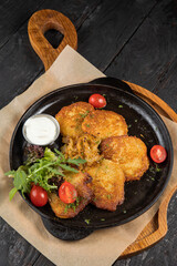 grilled meat with vegetables and spices on a black background
