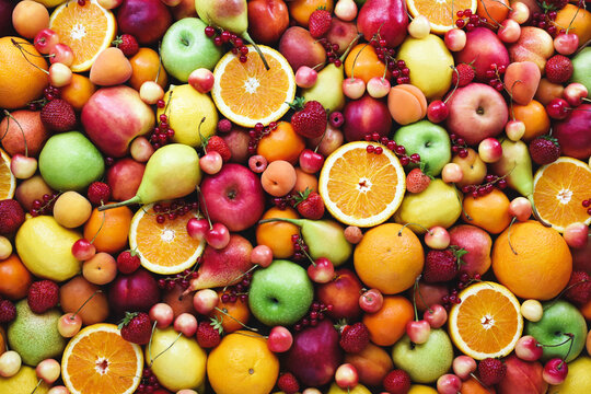 Fresh ripe organic fruits from market: pear and orange, cherry and lemon, apricot and berries, apple and banana