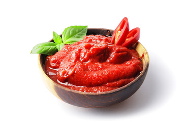 Tomato sauce in a bowl, Scented spice basil, Fresh ripe tomatoes, Chilli. Ingredient for the dish. Bowl full of tomato sauce with hot chili pepper, Spices and tomatoes isolated on white background.