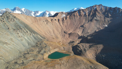 The emerald color of the water of a mountain lake. Drone view of a green mountain lake with a...
