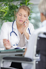 young woman doctor talking on phone