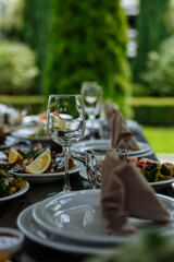 A table with beautiful dishes and prepared dishes on the summer terrace