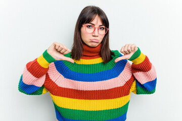 Young caucasian woman isolated on white background showing a dislike gesture, thumbs down....