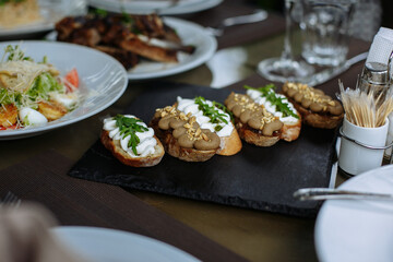 A table with beautiful dishes and prepared dishes on the summer terrace