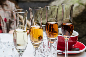 A tasting set of dessert wines in glass glasses.