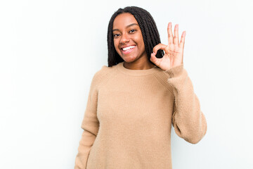 Young African American woman isolated on white background cheerful and confident showing ok gesture.