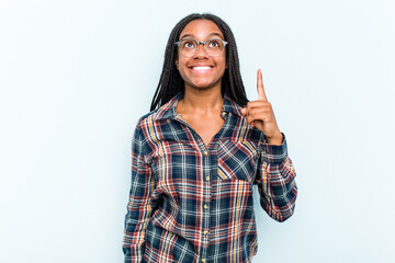 Young African American woman with braids hair isolated on blue background indicates with both fore...