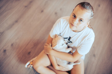 Dogs, children and pets concept - little child girl sitting on the floor with cute puppy.
