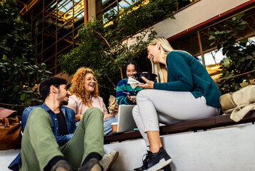Group of student siting in campus having lunch brake.