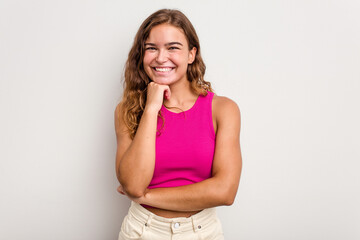 Young caucasian woman isolated on blue background smiling happy and confident, touching chin with hand.