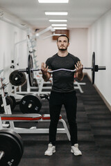 Naklejka na ściany i meble Young man trains his body to stay fit and have defined muscles.