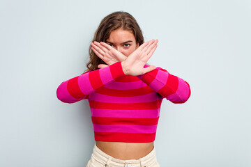 Young caucasian woman isolated on blue background doing a denial gesture