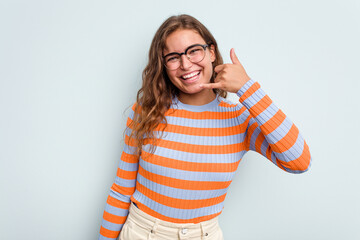 Young caucasian woman isolated on blue background showing a mobile phone call gesture with fingers.
