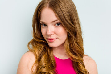 Fototapeta premium Portrait of pretty young caucasian woman isolated on blue background