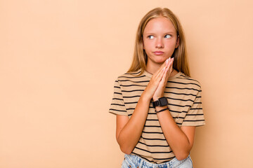 Caucasian teen girl isolated on beige background making up plan in mind, setting up an idea.