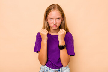 Caucasian teen girl isolated on beige background showing fist to camera, aggressive facial...