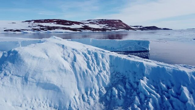 Huge high ice glacier at polar nature environment. Arctic winter landscape at global warming problem. Desert white land of snow and ice drone shot. 