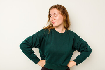 Young caucasian woman isolated on white background dreaming of achieving goals and purposes