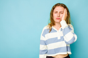 Young caucasian woman isolated on blue background who feels sad and pensive, looking at copy space.