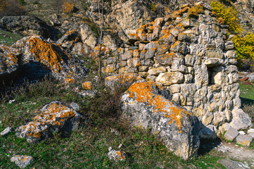 The city of the dead in North Ossetia. An ancient necropolis high in the mountains. A complex of ground and semi-underground structures-crypts. Ancient stone buildings in an ancient city. Ancient city