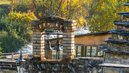 The bells in the ancient temple. An ancient necropolis high in the mountains. A complex of ground and semi-underground structures-crypts. Ancient stone buildings in an ancient city. Ancient city