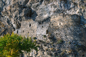 Dzivgis rock fortress.Loopholes in the fortress in the mountains. Towers of the fortress. Ancient stone buildings in an ancient city. A fortress in the mountains in an ancient city.