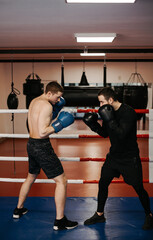 Fototapeta na wymiar Boxers train in the ring and in the gym