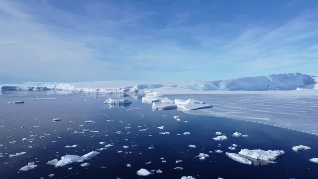 Snow covered antarctic surface aerial view flight. Frozen south pole. Desert white land of snow and ice drone shot. 