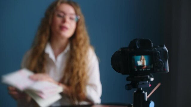 Online teacher live streaming lesson to students. Blogger filming content on camera. Confident woman talking in video chat conference. Female on remote work. Girl recording content. Focus transition.