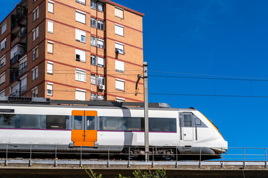 Commuter train on an elevated bridge in an apartment area in the city of Hospitalet de Llobregat in Barcelona in Spain