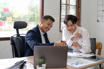 Financial advisory concept. Asian advisor showing plan of investment to clients in the consultancy office.