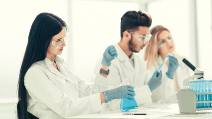 close up.modern woman sitting with colleagues at the laboratory