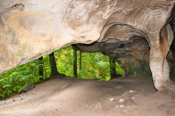 Huel Lee or Hohllay on the Mullerthal trail in Luxembourg, open cave with view to the forest,...