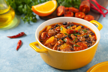 Pork stew with chorizo and black beans. Served with orange and seasoned with hot chili peppers....