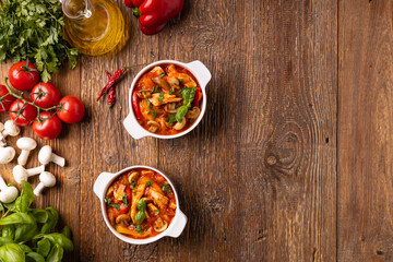 Chicken stew with peppers, mushrooms and tomatoes.