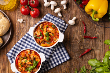 Chicken stew with peppers, mushrooms and tomatoes.