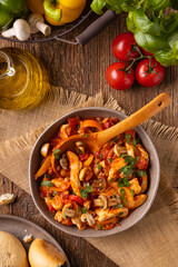 Chicken stew with peppers, mushrooms and tomatoes.